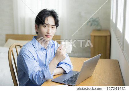 A young man using a computer 127241681