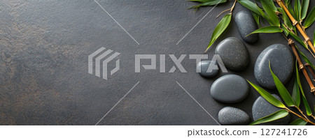 Zen Hot Stones with Bamboo on a Textured Slate Background 127241726
