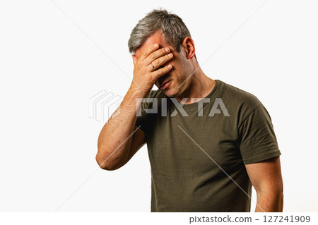 Frustrated man against a plain background 127241909