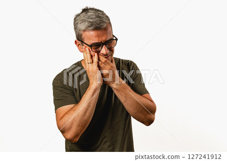 Man showing a mix of emotions in a comfortable setting 127241912