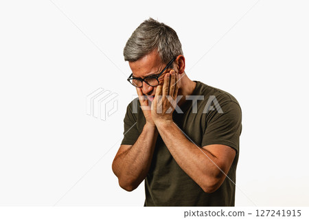 Man showing signs of deep contemplation indoors 127241915