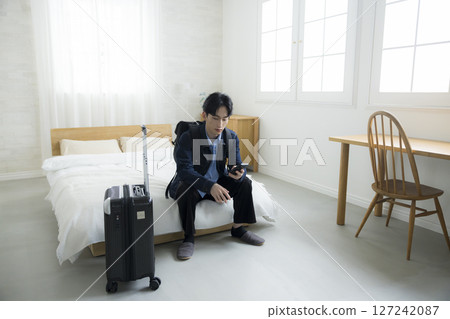 Businessman going out on business trip 127242087