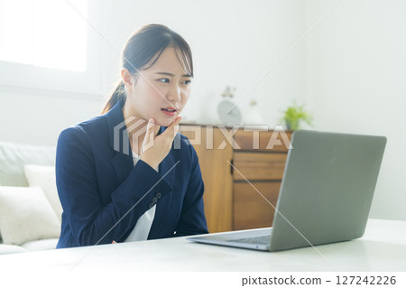 Young woman in a suit 127242226