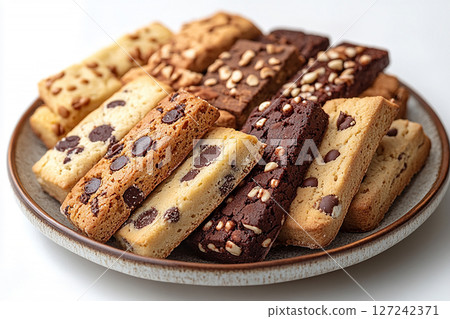 Variety of bakes and cookies in ceramic plate on a white background. 127242371