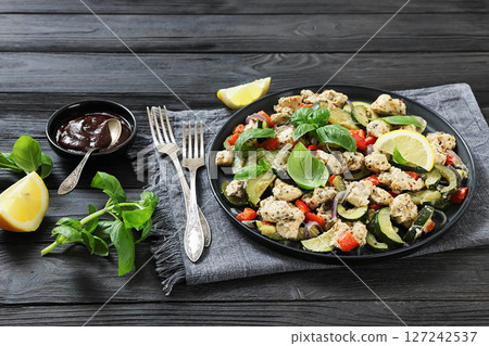 baked italian chicken and vegetables on a plate baked italian chicken and vegetables on a plate 127242537
