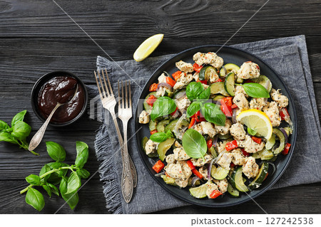 baked italian chicken and vegetables on a plate 127242538