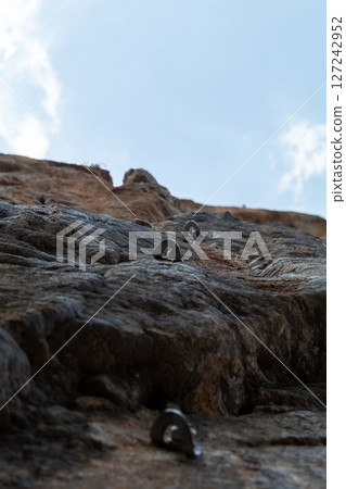 Rock Climbing Route with Bolts Leading to the Sky Rock Climbing Route with Bolts Leading to the Sky 127242952