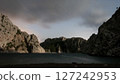 Serene Moonlit Cove Framed by Rugged Coastal Cliffs 127242953
