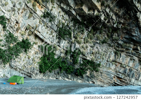 Wild Camping Beneath a Steep Rocky Cliff Face Wild Camping Beneath a Steep Rocky Cliff Face 127242957