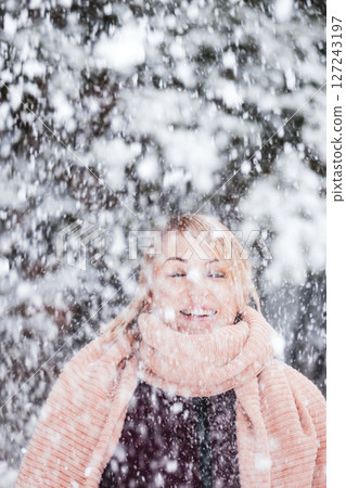 Blonde woman enjoy of snowing in the forest Blonde woman enjoy of snowing in the forest 127243197