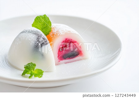 Delicious Japanese moti desserts. Close up. Asian rice daifuku dessert sweet mochi. Cut in half with filling. Traditional dessert mochi ice cream. Colorful rice cake. Fukashi manju. Culinary delights Delicious Japanese moti desserts. Close up. Asian rice daifuku dessert sweet mochi. Cut in half with filling. Traditional dessert mochi ice cream. Colorful rice cake. Fukashi manju. Culinary delights 127243449