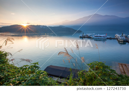 Sun Moon Lake scenery - Zhaowu Pier, the beautiful lake view reflects the fantastic sunrise sky. Famous tourist attractions in Nantou, Taiwan, Asia. 127243730