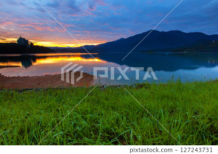 Sun Moon Lake scenery, beautiful lake view and fantastic sunrise sky. A famous tourist attraction in Nantou, Taiwan, Asia. Sun Moon Lake scenery, beautiful lake view and fantastic sunrise sky. A famous tourist attraction in Nantou, Taiwan, Asia. 127243731
