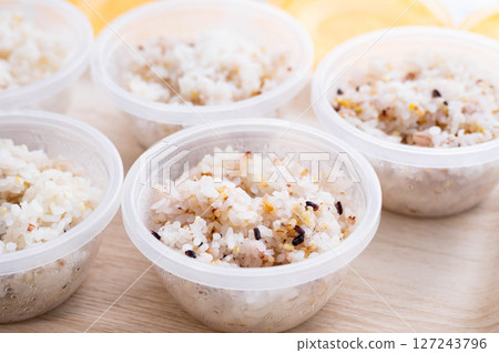 Mixed grain rice divided into small portions in a storage container Mixed grain rice divided into small portions in a storage container 127243796