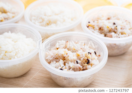 Rice divided into small portions in storage containers: mixed grain rice and white rice 127243797