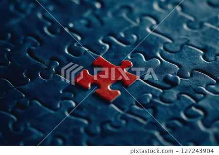One piece detail of puzzle is red on darl blue puzzle background. Different concept. Puzzle pieces grid, Jigsaw blue colour. Success mosaic solution template. Symbol of business strategy, completing 127243904