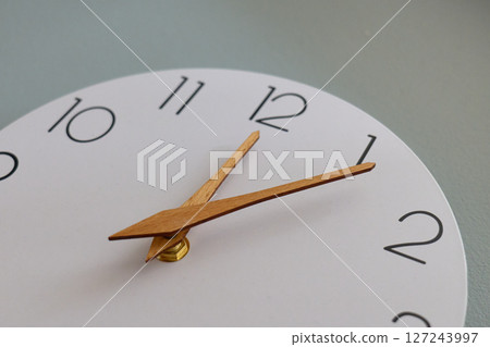 modern wall clock features wooden hands and clear numbers 127243997