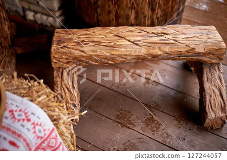 Wedding decoration in the Slavic style. A wooden bench firmly hammered together in the technique of firing Wedding decoration in the Slavic style. A wooden bench firmly hammered together in the technique of firing 127244057