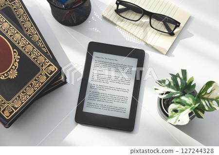 E-book reader device in home library 127244328