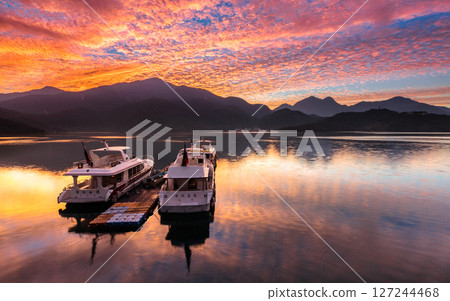 Sun Moon Lake scenery - beautiful lake view reflecting the fantastic sunrise sky. Famous tourist attraction in Nantou County, Taiwan, Asia. 127244468