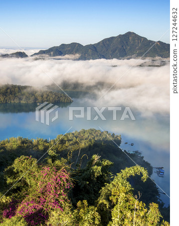 Sun Moon Lake scenery - beautiful lake view reflecting the fantastic sunrise sky. Famous tourist attraction in Nantou County, Taiwan, Asia. 127244632