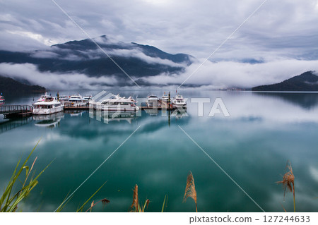 Sun Moon Lake scenery - beautiful lake view reflecting the fantastic sunrise sky. Famous tourist attraction in Nantou County, Taiwan, Asia. 127244633