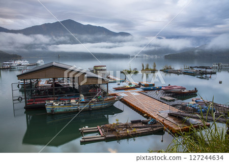 Sun Moon Lake scenery - beautiful lake view reflecting the fantastic sunrise sky. Famous tourist attraction in Nantou County, Taiwan, Asia. 127244634