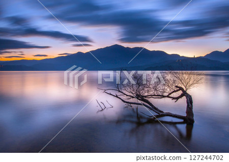 Sun Moon Lake - Trees in the Water Sun Moon Lake Scenery - Beautiful lake view reflecting the fantastic sunrise sky. Famous tourist attractions in Nantou County, Taiwan, Asia. 127244702