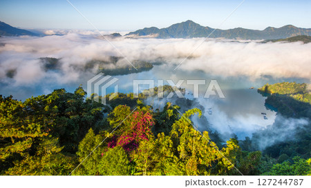 Sun Moon Lake scenery - beautiful lake view reflecting the fantastic sunrise sky. Famous tourist attraction in Nantou County, Taiwan, Asia. Sun Moon Lake scenery - beautiful lake view reflecting the fantastic sunrise sky. Famous tourist attraction in Nantou County, Taiwan, Asia. 127244787