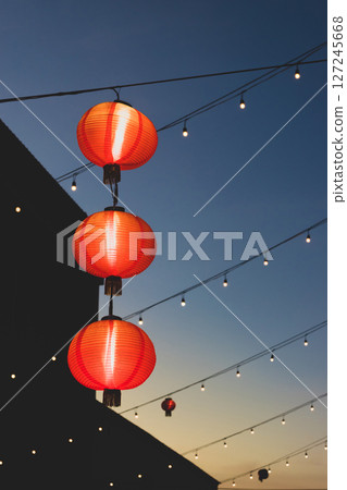 Red Chinese lanterns in blue sunset sky 127245668