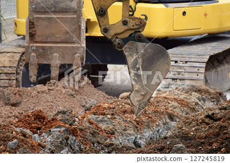 Mini excavator working in construction site 127245819