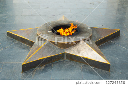 Eternal flame in a star-shaped memorial honoring fallen soldiers. A powerful symbol of remembrance, honor, and gratitude 127245858