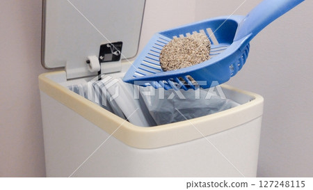 Cleaning Cat Litter Box Disposing of Clumped Litter in Trash Can with Liner, Pet Care Routine Cleaning Cat Litter Box Disposing of Clumped Litter in Trash Can with Liner, Pet Care Routine 127248115