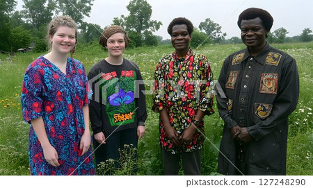 Diverse group of people standing together in a field 127248290