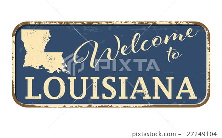 Welcome to Louisiana. A worn blue plaque with the name and outline of the state. Welcome inscription on the road sign 127249104