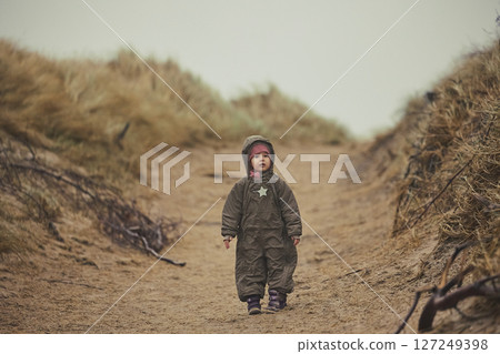 Adorable child playing in the grass in Denmark Adorable child playing in the grass in Denmark 127249398