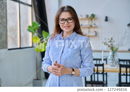 Portrait confident middle aged woman posing with folded hands 127249838