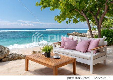 Relaxing sea view with white sofa, wooden table and cup of coffee on a tropical beach 127250602