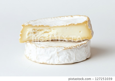 Fresh camembert cheese with sliced camembert isolated. Top view of camembert cheese piece on white background. Brie cheeses. Dairy products. Set of big round french cheeses with white mold. 127251039