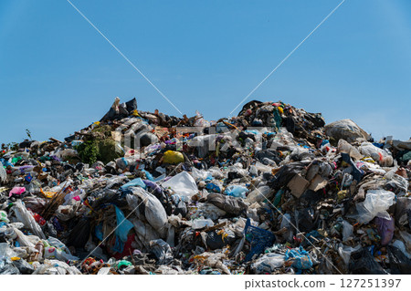 A massive landfill filled with heaps of plastic debris and garbage, showcasing the urgent need for effective waste management and recycling solutions A massive landfill filled with heaps of plastic debris and garbage, showcasing the urgent need for effective waste management and recycling solutions 127251397