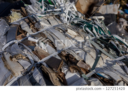 Improperly managed plastic and other waste piled high in a landfill highlights urgent environmental challenges for pollution and recycling efforts 127251420