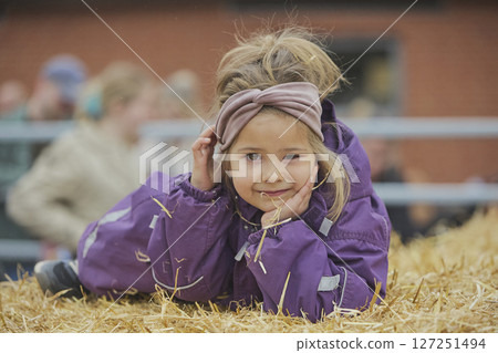 Charming child on a cows farm in Denmark Charming child on a cows farm in Denmark 127251494