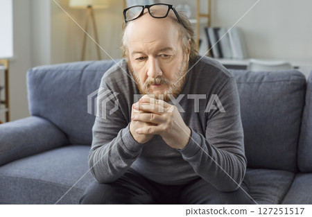Sad thoughtful bored older man alone looking feeling depressed, frustrated, lonely, suffering  127251517
