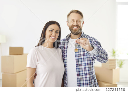 Portrait of a happy married couple in their new house or apartment on moving day 127251558