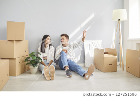 Happy Couple Dreaming And Planning Future Together During Move To New Home 127251596