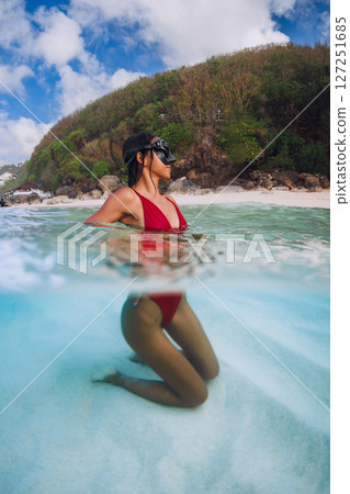 Attractive woman in clear ocean. Swimming girl in blue sea water Attractive woman in clear ocean. Swimming girl in blue sea water 127251685