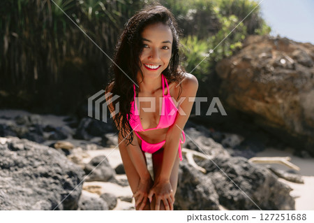 Portrait of smiling gorgeous woman in bikini at tropical sunny beach. Beautiful slim lady at ocean coast 127251688