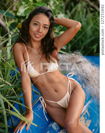 Gorgeous woman in bikini sitting on boat. Fashionable pretty woman Gorgeous woman in bikini sitting on boat. Fashionable pretty woman 127251692