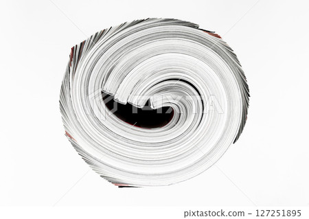 Background surface of few twisted magazines isolated on white background 127251895