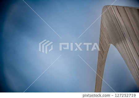 View from the base of the Gateway Arch National Park in St. Louis, Missouri showing the curve of metal against a blank sky View from the base of the Gateway Arch National Park in St. Louis, Missouri showing the curve of metal against a blank sky 127252719